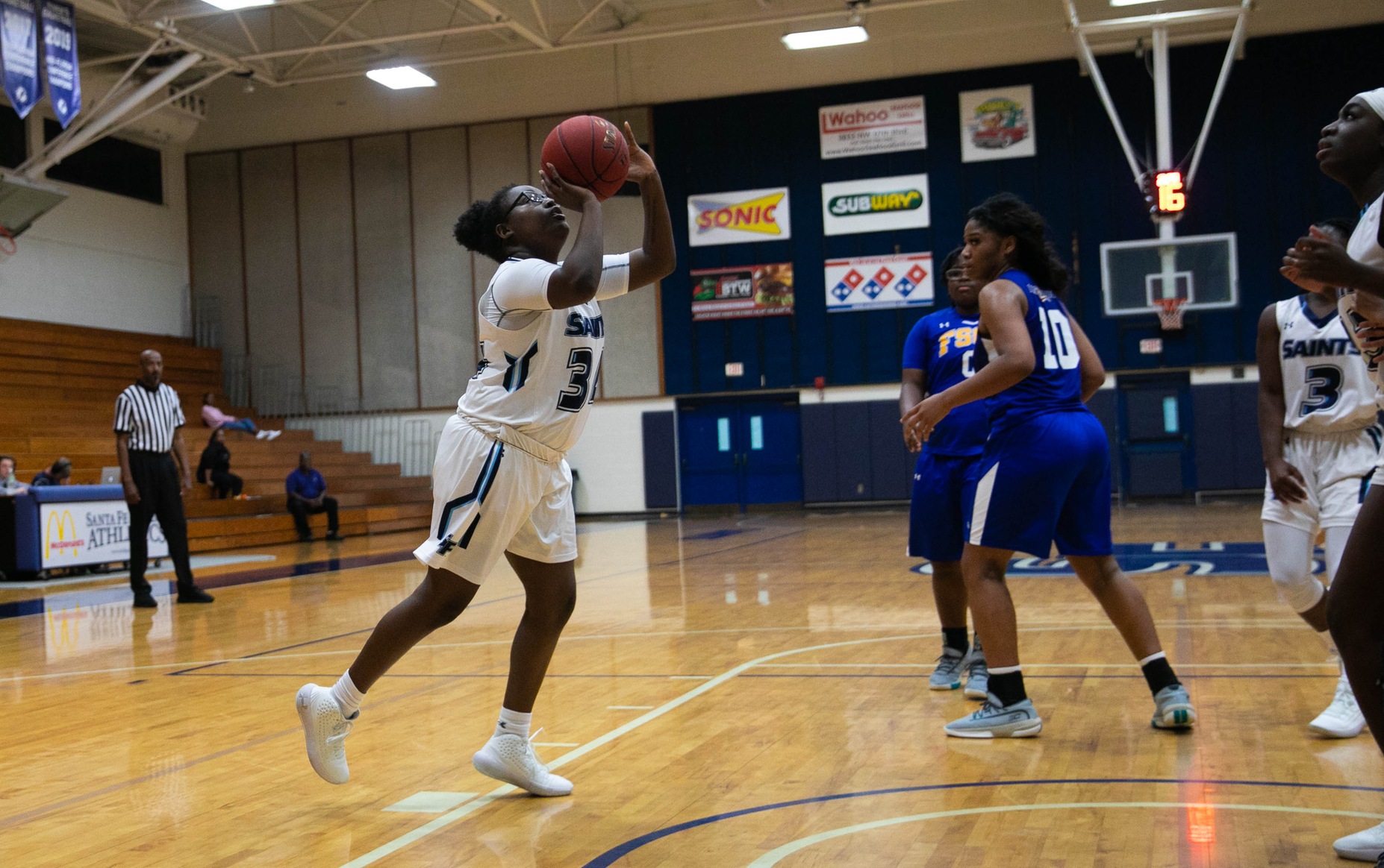 Saints player shoots the ball.